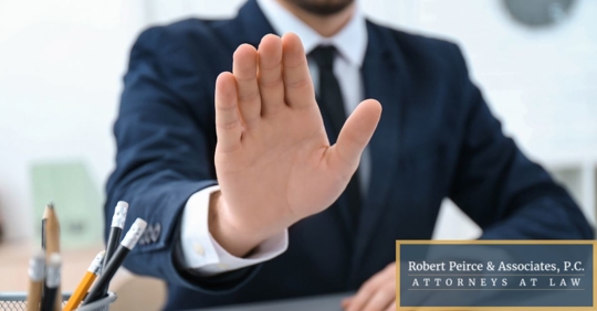 Employer holding up hand as a gesture to stop.