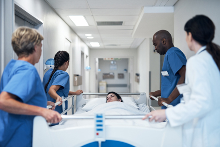 medical professionals rushing someone into a hospital