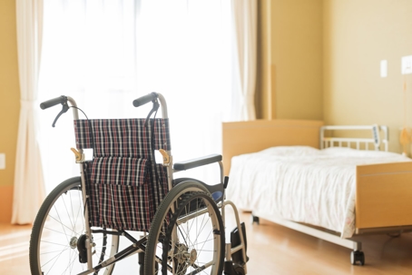 a wheelchair in an empty nursing home room