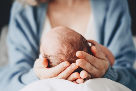 mother holding infant in her hands
