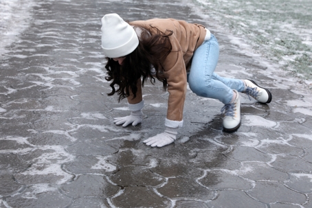 woman slipping on an icy sidewalk
